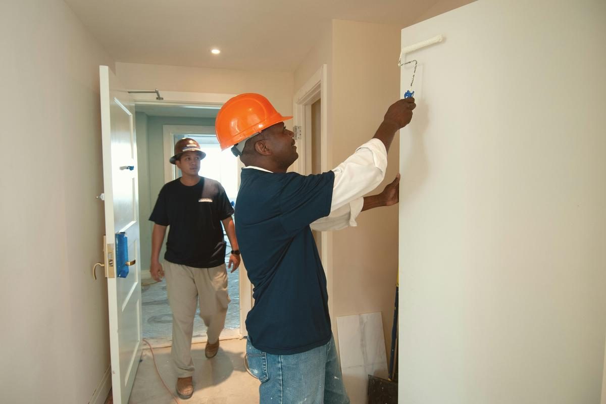 Painters working in a hallway