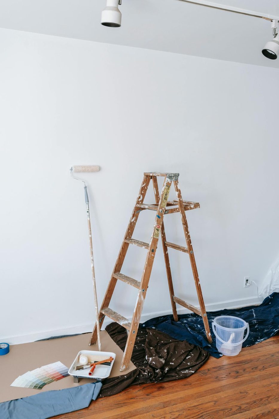 Ladder and drop cloths in a room