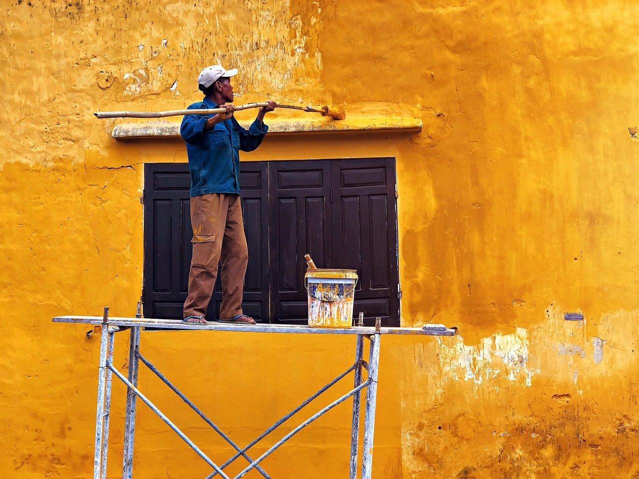 Painter on scaffolding